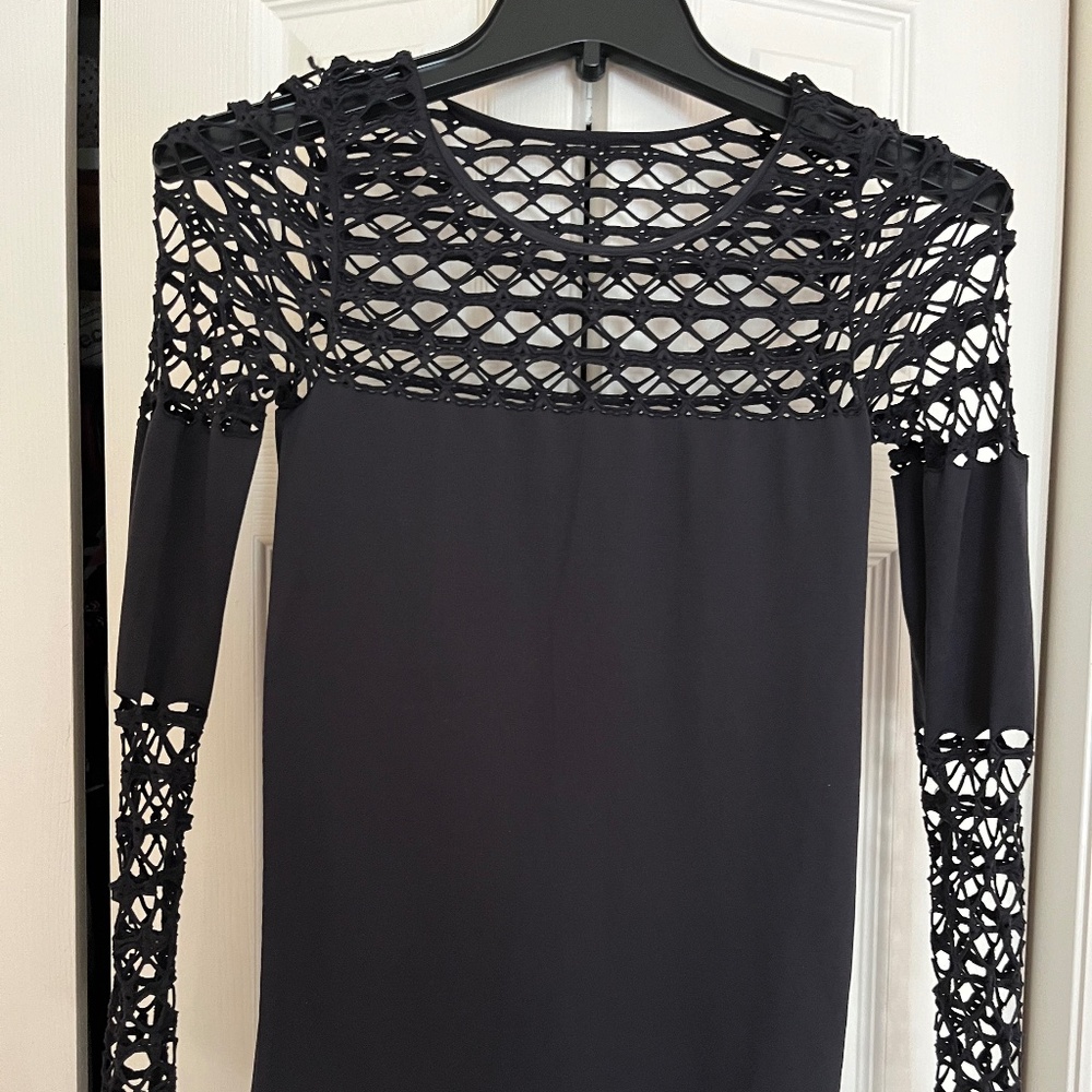 Black top with open weave on bodice and  sleeves